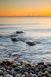 View from Arbon over Lake Constance at sunrise with stones in the foreground