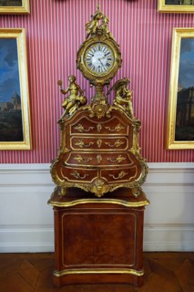 Historical clock on baroque furniture