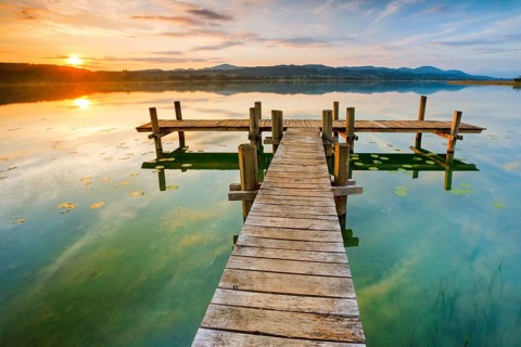 Wooden footbridge on Lake Pfaeffikon at sunrise