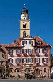 Twin house and church tower of St. John's Minster on the market square in Bad Mergentheim
