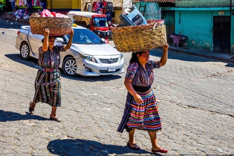Market woman with wrap skirt and colourful embroidered blouse