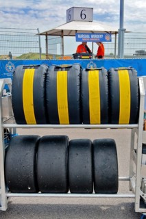 Mobile rack with racing tyres in protective cover for car racing