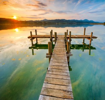 Wooden footbridge on Lake Pfaeffikon at sunrise