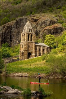 Notre Dame des Chazes church on the River Allier with canoeists