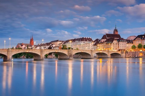 View of the old town of Basel illuminated at night with the Basel Cathedral