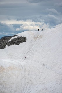 Hiker on old snow field
