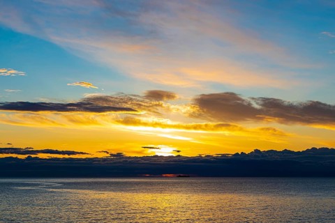 Sunrise behind dark clouds