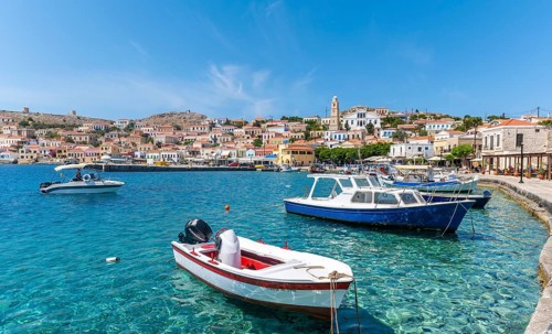 Fishing boats in the harbour of Halki with turquoise water