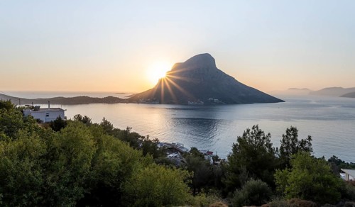 Sunshine over sea and hills in evening mood