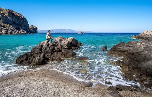 Young man sitting on a rock