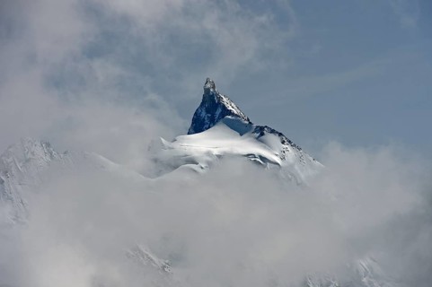 The Zinalrothorn peak rises out of the sea of clouds