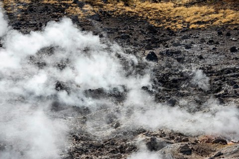Steaming black volcanic soil