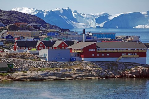 Buildings in front of icebergs