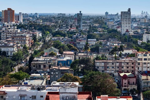 View over sea of houses with lots of greenery of the capital Havana