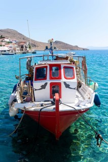 Fishing boat in Halki harbour with turquoise blue water