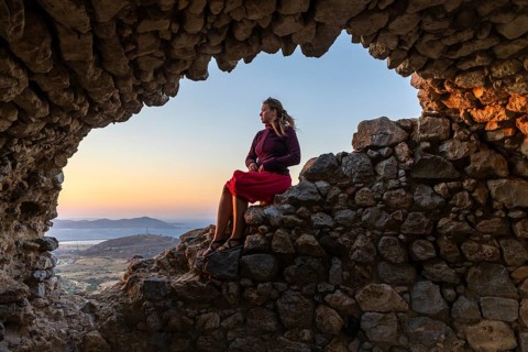 Young woman sitting on a wall