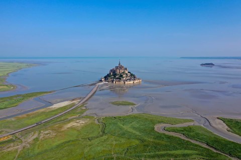 Drone shot from the mainland to the historic monastery of Le Mont Saint Michel