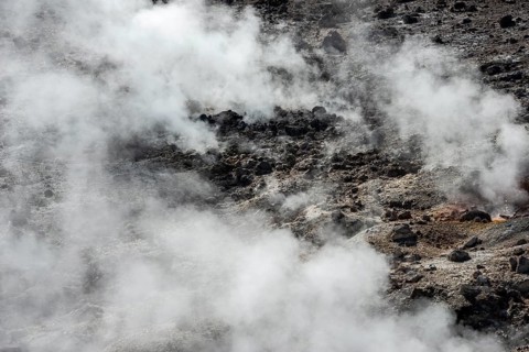 Steaming black volcanic soil