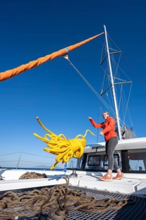 Young woman throws a rope on deck