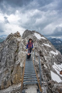 Hiker on a metal bridge on a rock