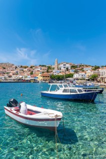 Fishing boats in the harbour of Halki with turquoise water