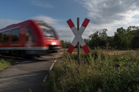 Unguarded level crossing with approaching train