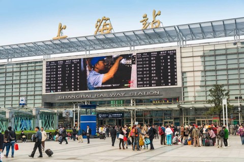 Central Station with people in front of the entrance and the information board