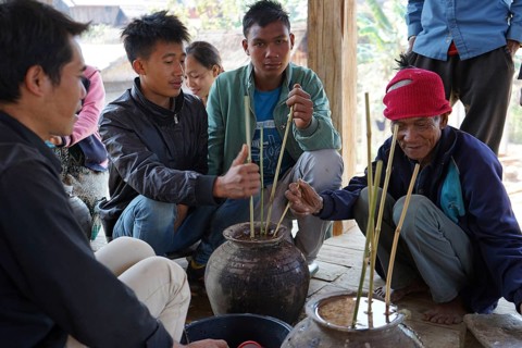 Members of the Khmu people drinking rice wine