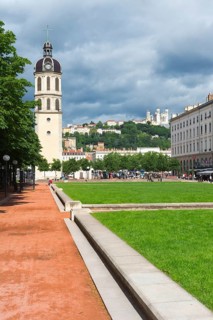 Bell tower of the former Hopital de la Charite and the Basilica Notre-Dame de Fourviere on the top of the hill