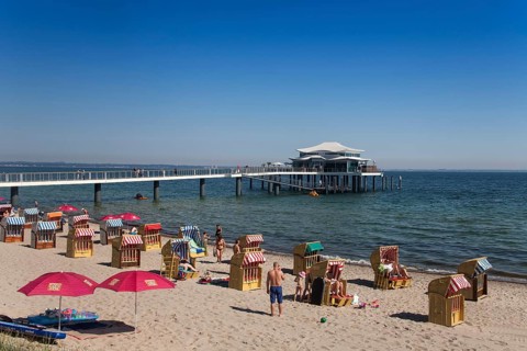 Beach chairs at Timmendorfer Strand with Seeschloesschenbruecke and Japanese teahouse