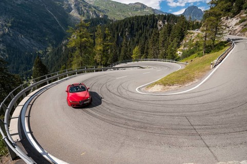 Red convertible travelling on the Maloja Pass