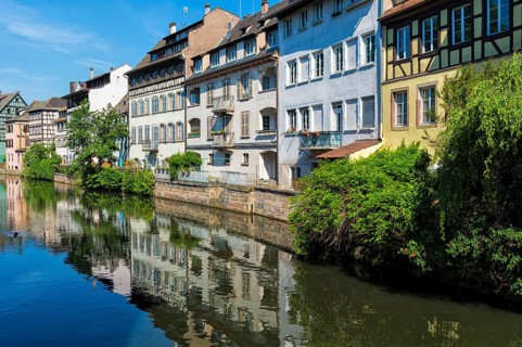 Half-timbered houses reflected in the ILL canal along the Quai de la Petite France