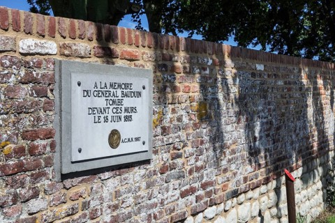 Memorial plaque to the fallen French General Bauduin in front of the garden wall of the Chateau d'Hougoumont