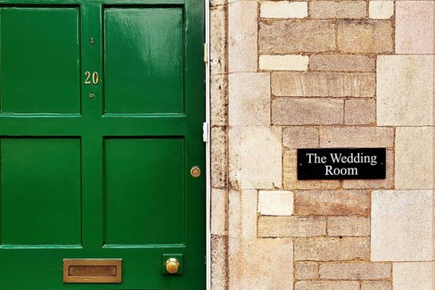 Facade with green door and sign Wedding Room