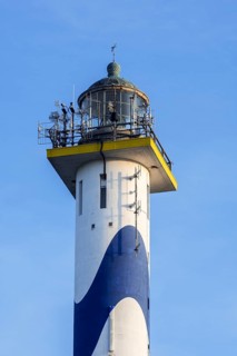 Lantern of the white-blue lighthouse Lange Nelle in the harbour of Ostend at the Belgian North Sea coast