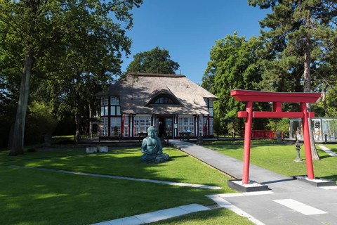 Thatched roof house Mikado Garden with Buddha rope