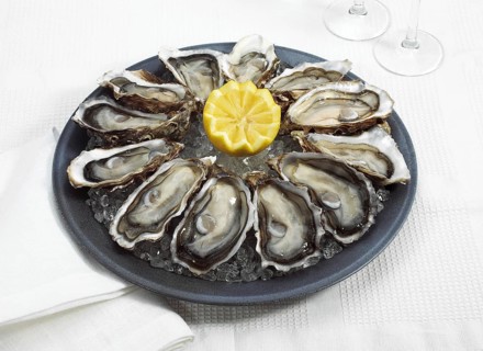 FRENCH OYSTER MARENNES D'OLERON ostrea edulis WITH YELLOW LEMON ON PLATE
