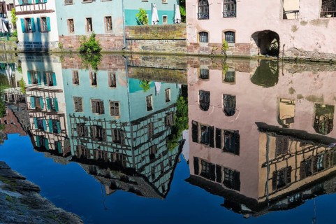 Half-timbered houses reflected in the ILL canal along the Quai de la Petite France