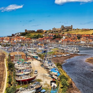 Village view of Whitby with harbour and view of the ruins of Whitby Abbey