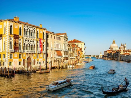 Gondola and boats next to Palazzo Franchetti Cavalli in the Grand Canal