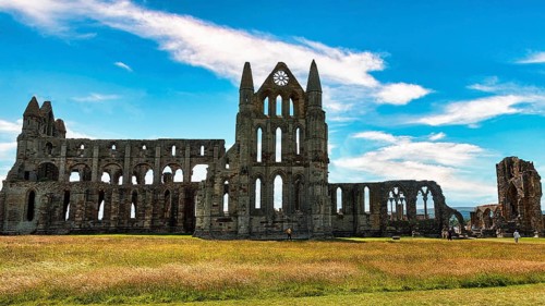 Ruin of the Gothic monastery Whitby Abbey with visitors