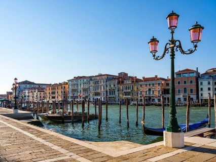 Boat mooring in front of historic house facade