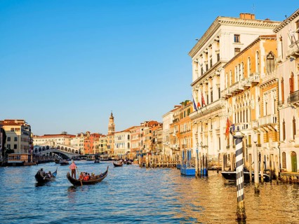 Gondolas next to historic house facades in the Grand Canal