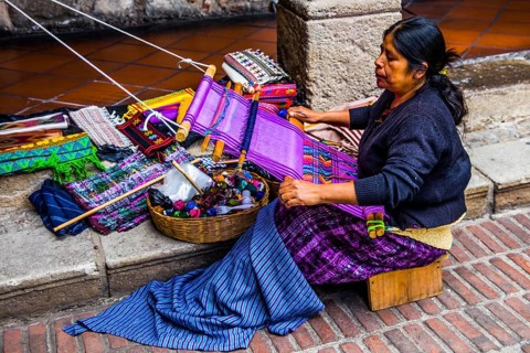 Woman weaving with loom