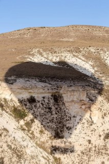 Shadow of hot air balloon flying over Cappadocia