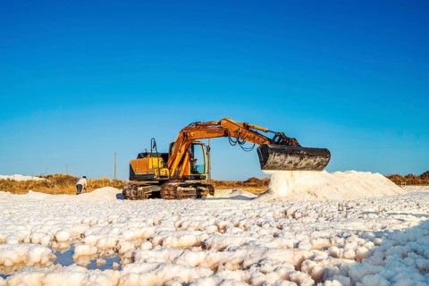 Excavator harvesting sea salt
