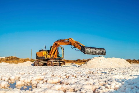 Excavator harvesting sea salt