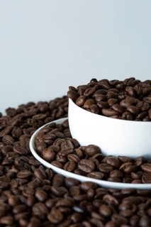A cup of coffee on coffee beans