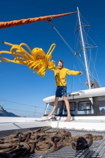 Sailor throws a yellow rope towards the camera