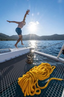 Young man jumps into the water